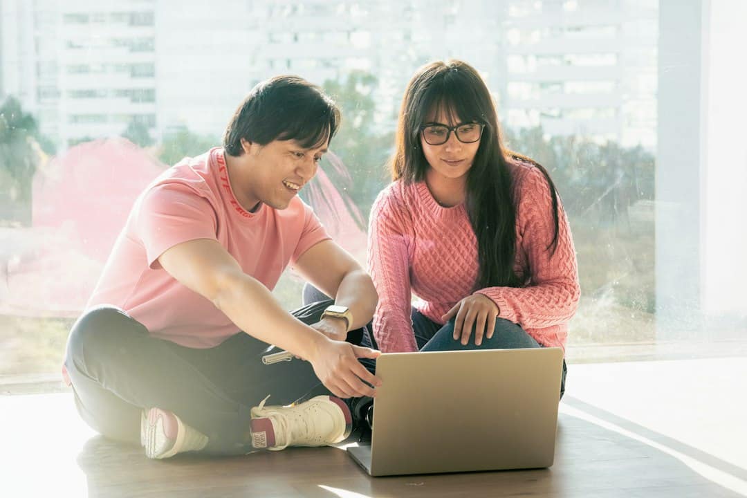 Two people sharing their plans while looking at a laptop.
